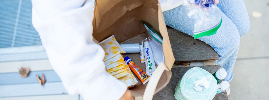 4 of 6, A brown bag with Personal Hygiene Program items in it